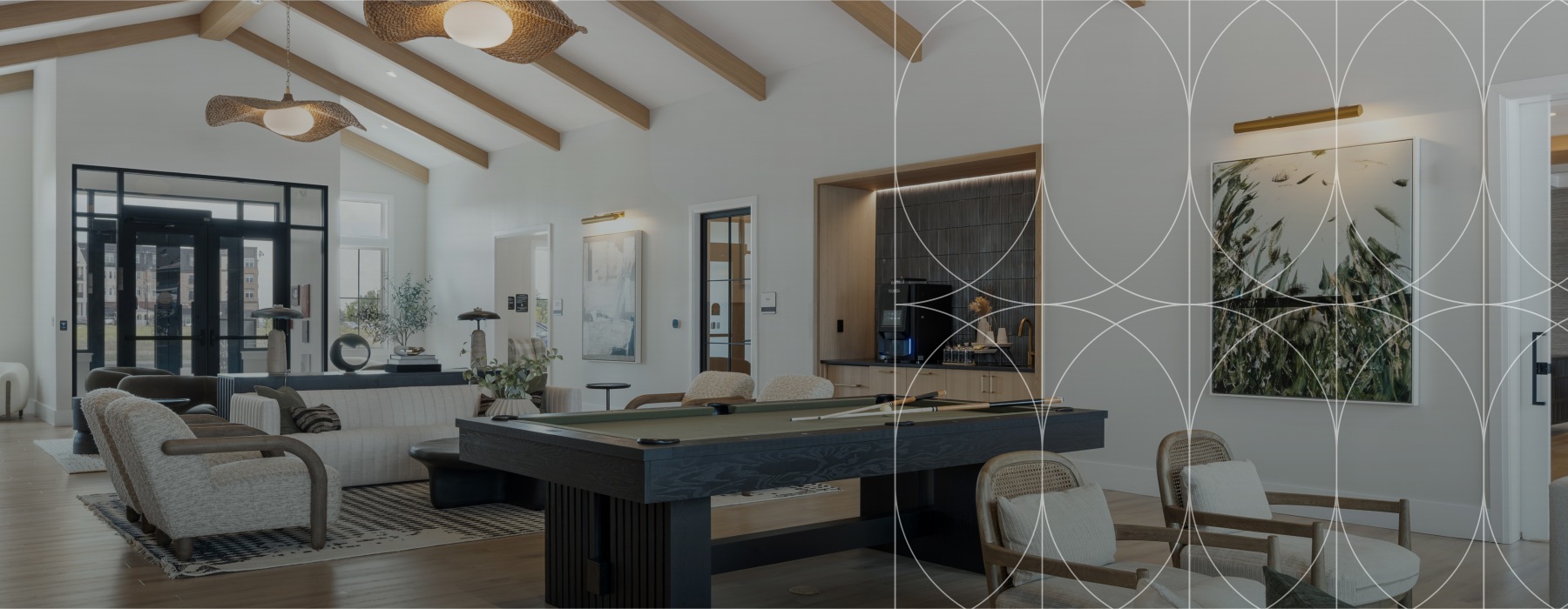 The resident lounge at Alta Oak and Pine apartments in Londonderry, NH, featuring a geometric overlay design.