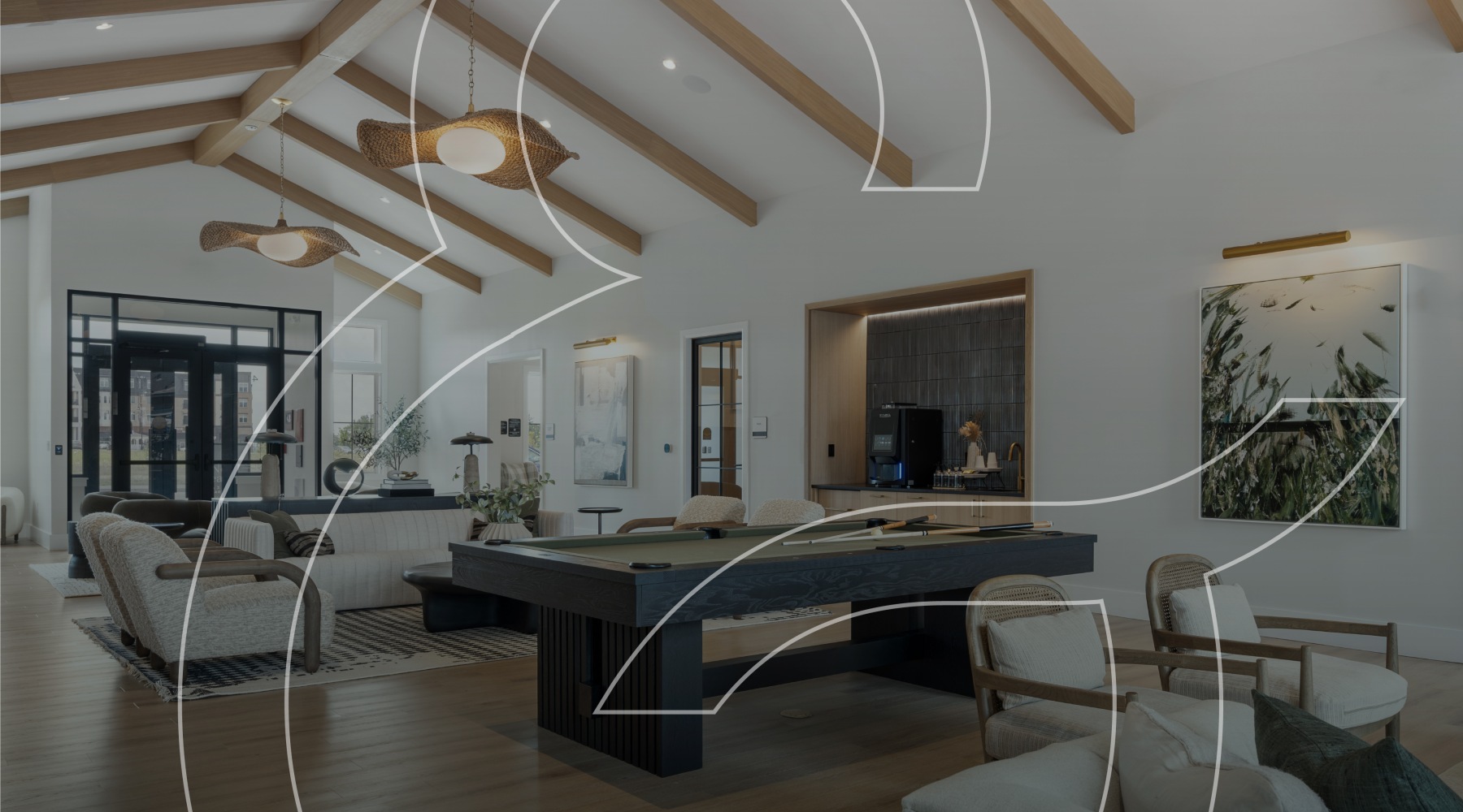 a clubhouse with billiards and soft couch and chair seating