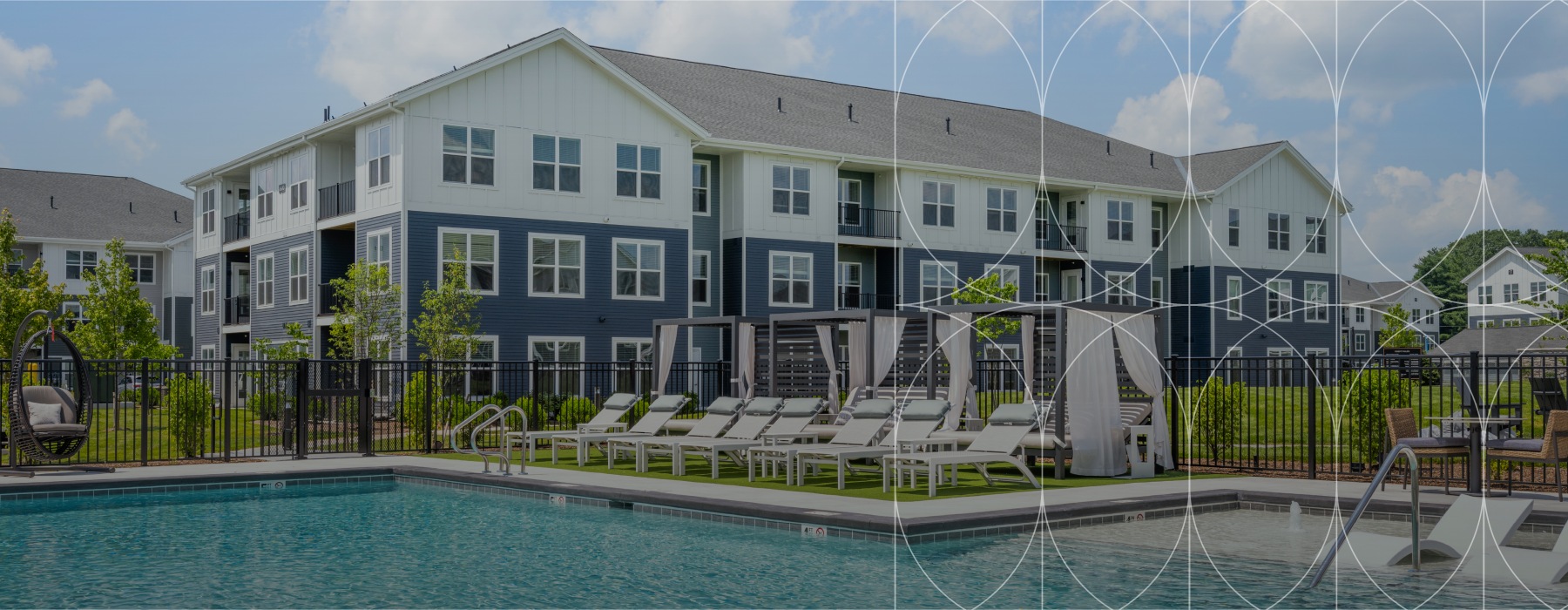 The pool area at Alta Oak and Pine apartments in Londonderry, featuring lounge chairs and a view of the apartment exteriors.